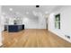 Open-concept space featuring hardwood floors, white walls, and a modern kitchen at 2661 Fleur De Lis Pl, Atlanta, GA 30360