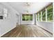 Bright sunroom with hardwood floors, many windows, and a ceiling fan at 2661 Fleur De Lis Pl, Atlanta, GA 30360