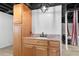 Basement wet bar with stone counters and wooden cabinets at 2661 Fleur De Lis Pl, Atlanta, GA 30360