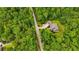 Aerial view shows a home nestled amongst mature trees at 7269 Tyree Rd, Winston, GA 30187