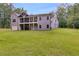 Back of home showing spacious lawn, and screened porch at 7269 Tyree Rd, Winston, GA 30187