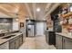 A unique bar features a stainless fridge, granite counters, and a stylish wood plank ceiling at 7269 Tyree Rd, Winston, GA 30187