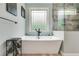 Bathroom features a soaking tub and a window, with light neutral paint at 7269 Tyree Rd, Winston, GA 30187