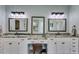 Bathroom featuring double vanities, framed mirrors, modern fixtures, and a makeup vanity at 7269 Tyree Rd, Winston, GA 30187