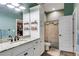 Well lit bathroom featuring a granite countertop vanity, large mirror and a separate toilet room at 7269 Tyree Rd, Winston, GA 30187