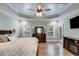 Bedroom with tray ceilings, hardwood floors, and a window offering views of the outdoors at 7269 Tyree Rd, Winston, GA 30187