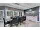 Dining room featuring large windows, stylish lighting, and built-in cabinets at 7269 Tyree Rd, Winston, GA 30187