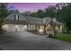 Beautiful one-story home at dusk, with a covered porch, two-car garage, and professionally landscaped yard at 7269 Tyree Rd, Winston, GA 30187