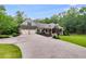A spacious one-story home with a lush lawn, covered porch, and a two-car garage, nestled in a wooded area at 7269 Tyree Rd, Winston, GA 30187