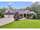 Charming home featuring a manicured lawn, inviting front porch, and a spacious two-car garage at 7269 Tyree Rd, Winston, GA 30187