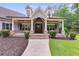 Inviting covered porch with stone columns, a brick base and walkway leading to the front door at 7269 Tyree Rd, Winston, GA 30187