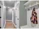 Inviting hallway with hardwood floors, white trim, and convenient coat rack at 7269 Tyree Rd, Winston, GA 30187