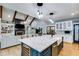 Open kitchen concept with a large eat-in island with stone countertops and stainless appliances at 7269 Tyree Rd, Winston, GA 30187