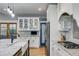 Kitchen area featuring stone countertops, white cabinets, and stainless steel appliances at 7269 Tyree Rd, Winston, GA 30187