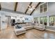 Open concept living room with wood floors, large windows, and vaulted ceiling at 7269 Tyree Rd, Winston, GA 30187