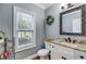 Well-lit powder room with granite counter, decorative mirror, and modern fixtures at 7269 Tyree Rd, Winston, GA 30187