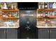 The basement bar area features a hidden safe with a display of liquor and a stacked stone wall at 7269 Tyree Rd, Winston, GA 30187
