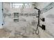 The spacious shower features neutral tiling, a built-in niche, and bronze fixtures at 7269 Tyree Rd, Winston, GA 30187