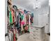 Spacious walk-in closet with custom shelving, drawers, and elegant chandelier lighting at 7269 Tyree Rd, Winston, GA 30187