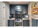 Wet bar area boasts stainless steel appliances, custom cabinetry, and granite countertops at 7269 Tyree Rd, Winston, GA 30187