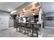 Basement wet bar with barstool seating, granite countertops, and custom lighting at 7269 Tyree Rd, Winston, GA 30187
