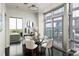 Dining area featuring a glass table, modern chairs, and city views at 923 Peachtree Ne St # 1238, Atlanta, GA 30309