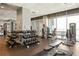 Well-lit fitness area with weight machines, dumbbells, and a large window overlooking the city at 923 Peachtree Ne St # 1238, Atlanta, GA 30309