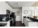 Modern kitchen with sleek appliances, white cabinetry and a breakfast bar at 923 Peachtree Ne St # 1238, Atlanta, GA 30309