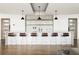 Modern kitchen featuring a bar with six stools, stylish pendant lighting, and marble backsplash at 923 Peachtree Ne St # 1238, Atlanta, GA 30309