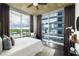 Inviting bedroom with ample natural light, city views, and stylish decor at 923 Peachtree Ne St # 1238, Atlanta, GA 30309