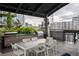This outdoor kitchen and dining area boasts built-in grills, a sink, and seating with city views at 923 Peachtree Ne St # 1238, Atlanta, GA 30309