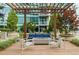 Relaxing outdoor lounge area with a pergola, comfortable seating, fire pit, and landscaped surroundings at 923 Peachtree Ne St # 1238, Atlanta, GA 30309