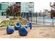 Outdoor patio area offers cozy blue chairs, a view of the pool and lush landscaping around the building at 923 Peachtree Ne St # 1238, Atlanta, GA 30309