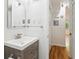 Bathroom featuring vanity with chrome fixtures, large mirror, and a tile backsplash at 1284 Piedmont Ne Ave # 12, Atlanta, GA 30309