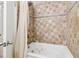 Bathroom featuring shower, tile backsplash, and a bathtub with jacuzzi jets and a shower curtain at 1284 Piedmont Ne Ave # 12, Atlanta, GA 30309