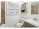 Well-lit bathroom features a decorative stone backsplash, vanity, medicine cabinet, and updated plumbing fixtures at 1284 Piedmont Ne Ave # 12, Atlanta, GA 30309