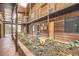 Building courtyard with wooden beams, a garden area, and a stone walkway at 1284 Piedmont Ne Ave # 12, Atlanta, GA 30309