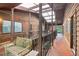 Enclosed patio featuring wood beams, covered ceiling and wooden bench overlooking greenery at 1284 Piedmont Ne Ave # 12, Atlanta, GA 30309