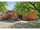 Brick building with a rear parking lot and staircases, partially shaded by a mature tree at 1284 Piedmont Ne Ave # 12, Atlanta, GA 30309