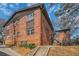 Exterior view of brick apartment building surrounded by mature trees and green landscaping at 1284 Piedmont Ne Ave # 12, Atlanta, GA 30309