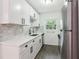Modern kitchen with stainless steel appliances, white cabinets, updated fixtures, and a neutral backsplash at 1284 Piedmont Ne Ave # 12, Atlanta, GA 30309