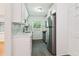 Updated kitchen with white cabinets, stainless steel appliances, stylish black faucet, and hardwood floors in adjoining room at 1284 Piedmont Ne Ave # 12, Atlanta, GA 30309