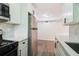 Well-appointed kitchen featuring stainless steel appliances, light cabinets, white countertop, and hardwood flooring at 1284 Piedmont Ne Ave # 12, Atlanta, GA 30309