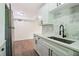 Bright kitchen with stainless steel appliances, white cabinets, granite counters, and hardwood floors nearby at 1284 Piedmont Ne Ave # 12, Atlanta, GA 30309