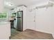 Traditional kitchen with stainless steel refrigerator, white cabinets and wood-look flooring at 1284 Piedmont Ne Ave # 12, Atlanta, GA 30309