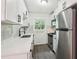 Modern kitchen with white cabinets, stainless steel appliances, a white countertop, and a stylish black kitchen faucet at 1284 Piedmont Ne Ave # 12, Atlanta, GA 30309