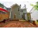 A spacious home backyard featuring a small patio, lush greenery and mature trees, and a cozy deck area at 1830 Broadway St, Decatur, GA 30035
