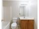 Neutral bathroom features a single sink vanity with storage, a toilet, and a tub and shower combination with light fixtures at 1830 Broadway St, Decatur, GA 30035