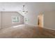 Spacious carpeted bedroom with a ceiling fan, a large window, and a glass door for natural light and backyard access at 1830 Broadway St, Decatur, GA 30035