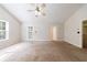 This is a large carpeted bedroom with natural light coming from a window and a glass door to the outdoor patio at 1830 Broadway St, Decatur, GA 30035